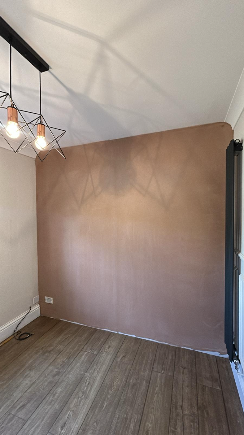 Finished plastered room with new flooring and pendant lighting