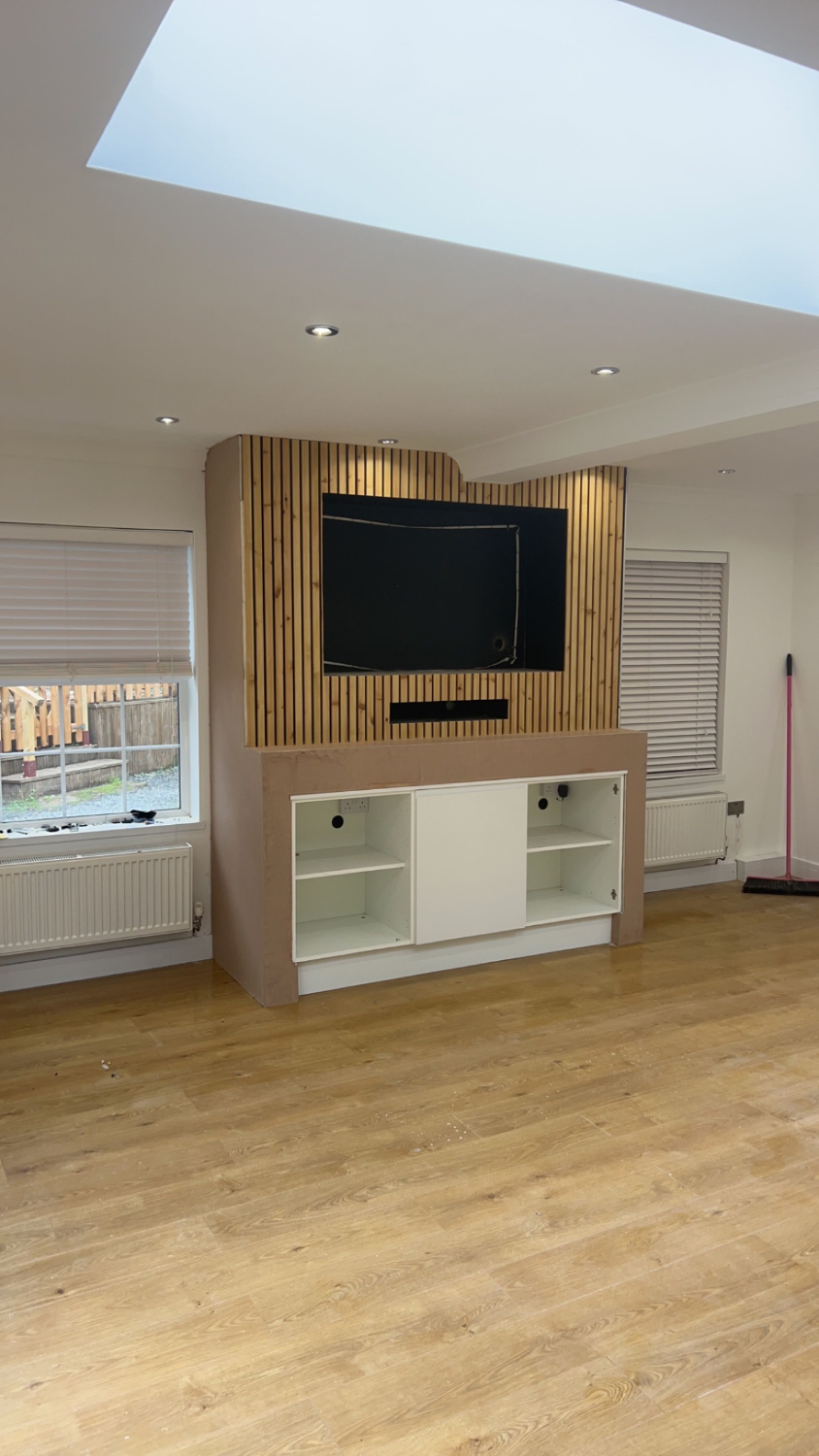 Finished living room with media wall, flooring and lighting complete