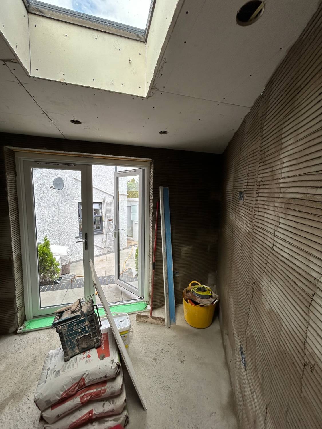 Room with new skylight and patio doors during building work
