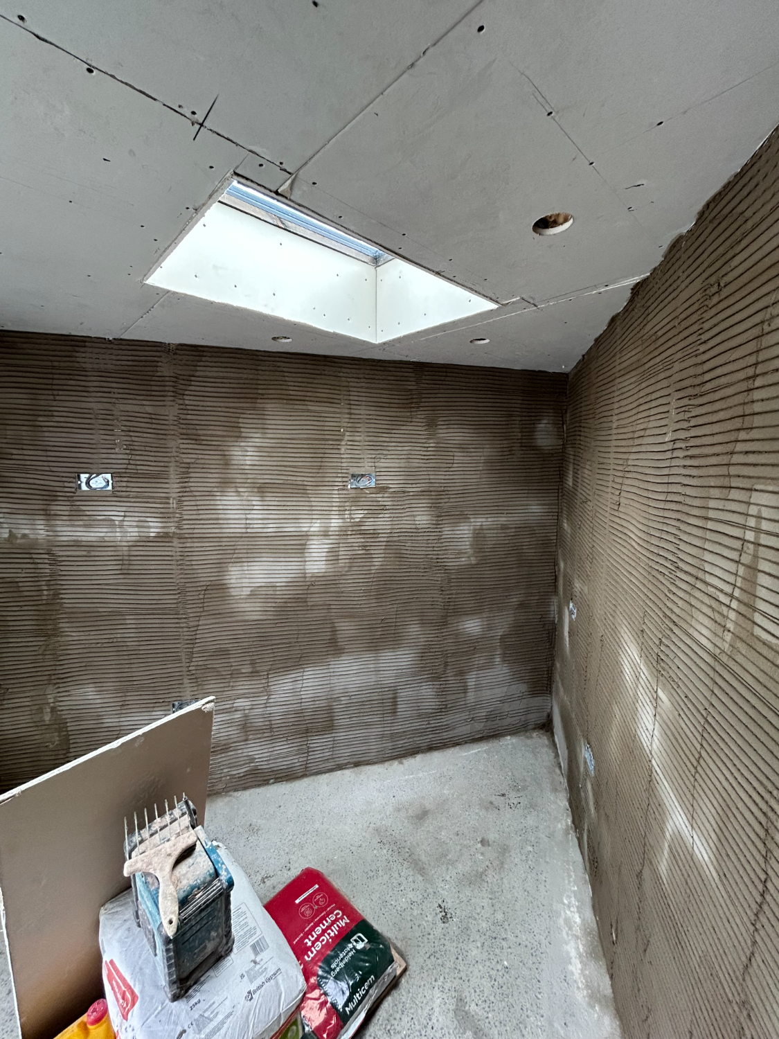 Corner of a room in backing coat below a skylight