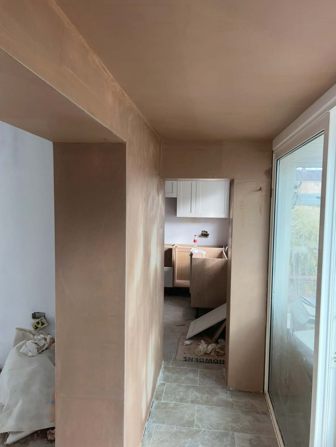Plastered opening with a view through to an adjoining room
