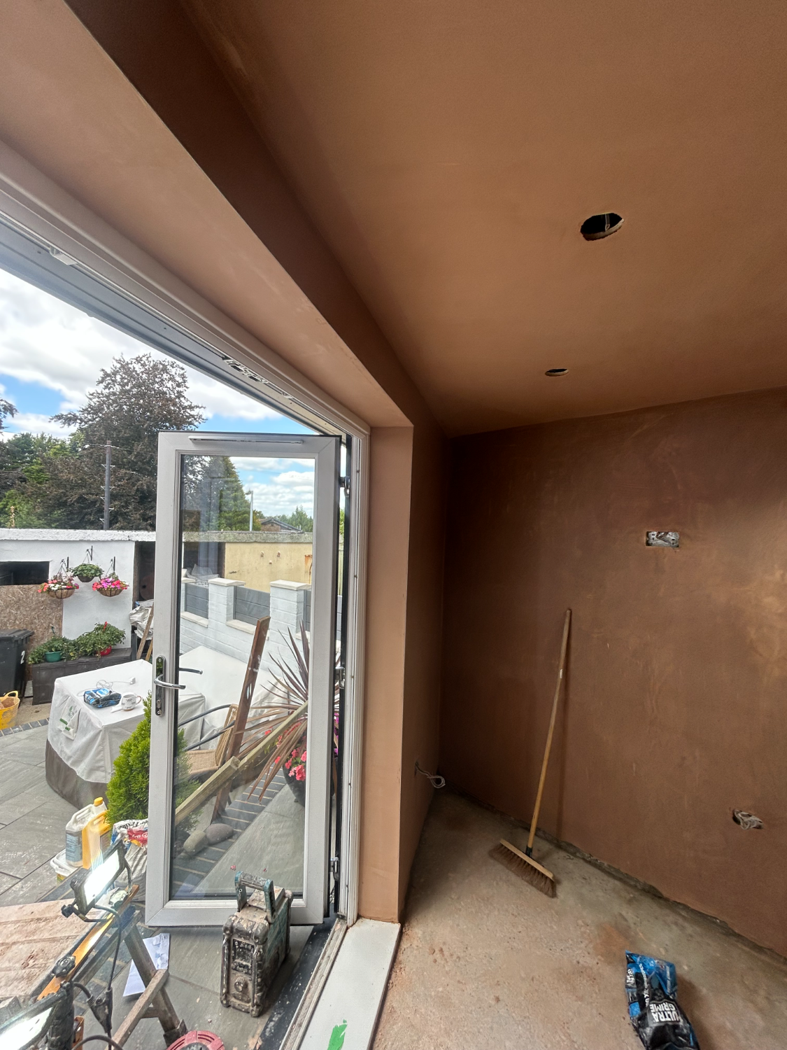 Open-plan room with new bifold doors onto a patio